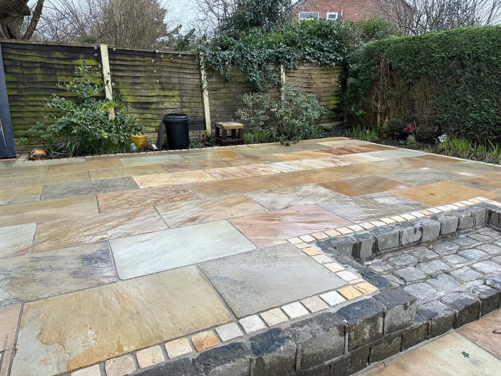 Natural stone driveway entrance with detailed edging in Preston