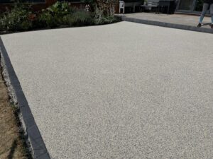 Completed resin patio with charcoal block edging