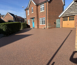 Textured shot of UV-stable natural aggregate used in a professionally installed resin bound driveway.