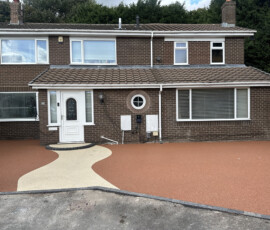A close-up view of a smooth, permeable golden aggregate resin bound driveway surface.