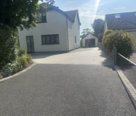 Curb appeal enhancement: Before and after comparison showing a worn tarmac drive transformed into a contemporary grey resin bound driveway.