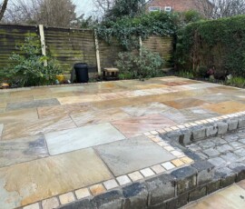 Natural stone driveway entrance with detailed edging in Preston